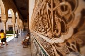 Travel photography:Arabesque facade detail in the Patio de los Arrayanes (Court of the Myrtles), also called the Patio de la Alberca (Court of the Blessing or Court of the Pond) in the Nazrin palace of the Granada Alhambra, Spain