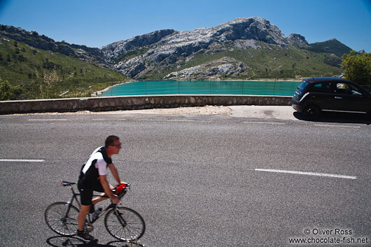 Cyclist at the Embassament de Cuber water reservoir in the Serra de Tramuntana mountains