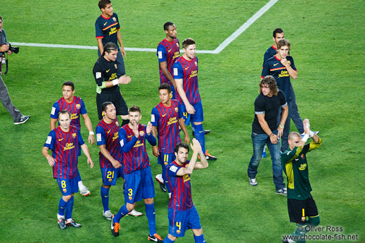 The team of FC Barcelona with new arrival Cesc Fábregas on their victory lap after winning the Supercup 2011