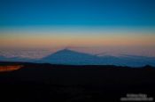 Travel photography:Triangular shadow of Teide Volcano at sunset viewed from the Alta Vista Refugio, Spain