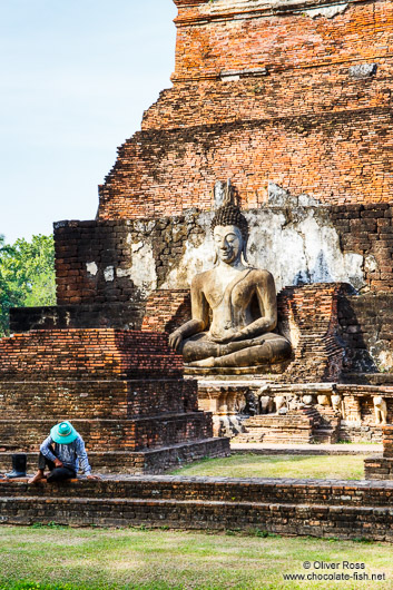 Man with Buddha at the Sukhothai temple complex
