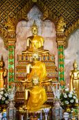 Travel photography:Row of Buddha statues at a temple in Bangkok, Thailand