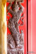 Travel photography:Sculpture in a window shutter at Wat Benchamabophit in Bangkok, Thailand