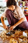 Travel photography:Woman cutting pieces for a parasol at the Bo Sang parasol factory, Thailand