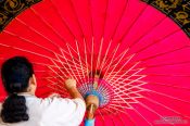 Travel photography:Adding the finishing touches to a large parasol at the Bo Sang parasol factory, Thailand