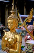 Travel photography:Golden Kinnara figure at Wat Phra Kaew in Bangkok, Thailand