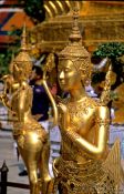 Travel photography:Golden Kinnara figures at Wat Phra Kaew in Bangkok, Thailand