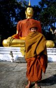 Travel photography:Monk with giant Buddha near Chiang Rai, Thailand