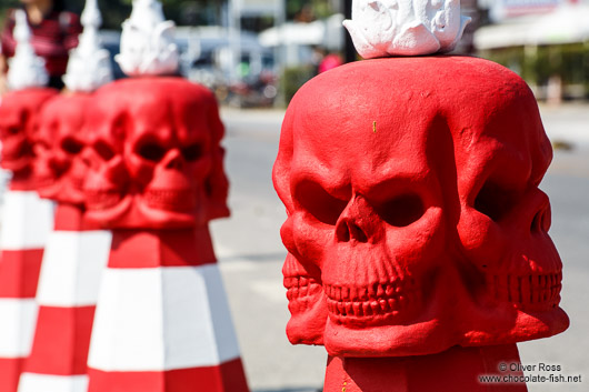 Red skulls on traffic cones at the Chiang Rai Silver Temple