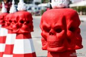 Travel photography:Red skulls on traffic cones at the Chiang Rai Silver Temple, Thailand