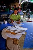 Travel photography:Woman making hand fans at the Bo Sang parasol factory, Thailand