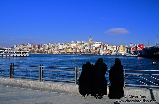 Three women in burkas enjoy the view across the Golden Horn
