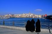 Travel photography:Three women in burkas enjoy the view across the Golden Horn, Turkey
