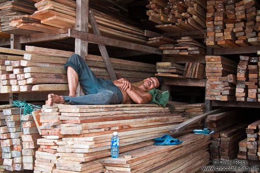 Man sleeping in a wood shop in Danang