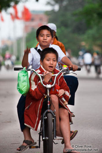 Kids riding a bike in Hue