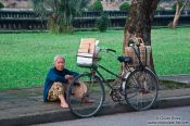 Travel photography:Hue woman with bike, Vietnam