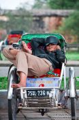Travel photography:Hue ricksha driver having a nap, Vietnam