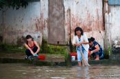 Travel photography:Women doing their laundry in the river at Can Tho , Vietnam