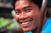 Travel photography:Happy food vendor at the Can Tho floating market , Vietnam