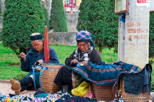 Hmong women sewing clothes in Sapa