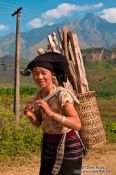 Travel photography:Hmong woman with fire wood near Sapa, Vietnam