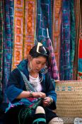 Travel photography:Hmong girl sewing in Sapa , Vietnam