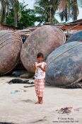 Travel photography:Girl in front of the round boats typical for Mui Ne , Vietnam